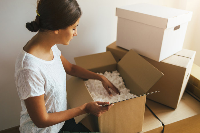 Woman-packing-boxes